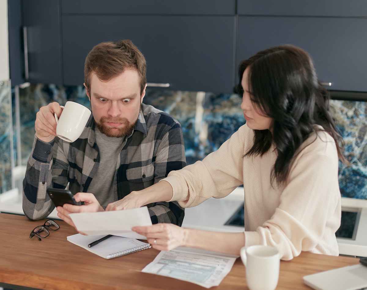 Photo by Mikhail Nilov from Pexels https://www.pexels.com/photo/man-couple-people-woman-6964111/tax-return-form-and-notebooks-on-the-table-6863514/)